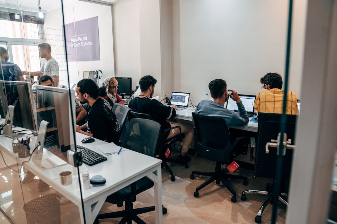 Small editorial team working together in a bright modern newsroom office